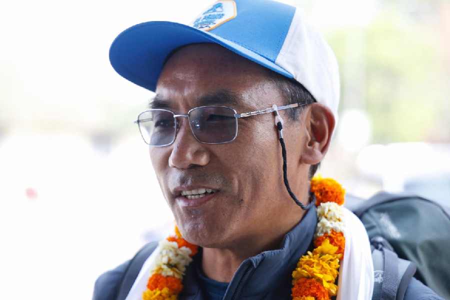 Renowned Sherpa mountain guide Kami Rita is garlanded at the Tribhuvan airport as he prepares to depart to ascend Mount Everest for the record 31st time, in Kathmandu, Sunday, April 20, 2025