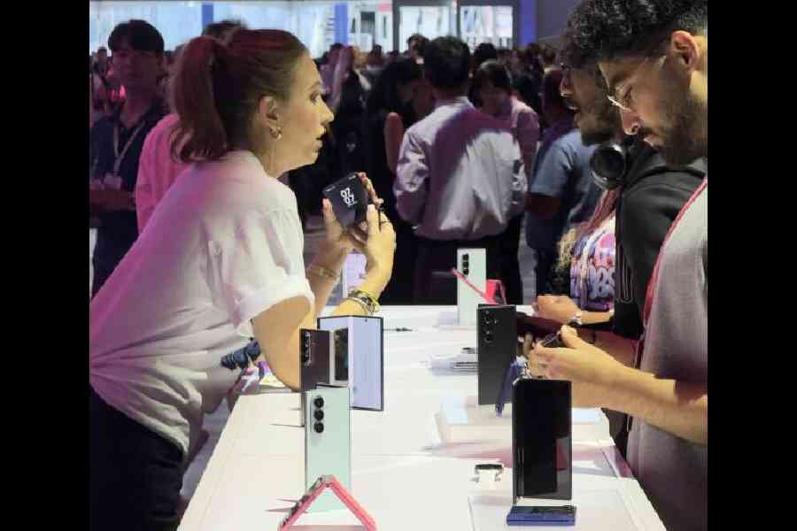 Tech enthusiasts discuss the new Samsung products at an event in New York