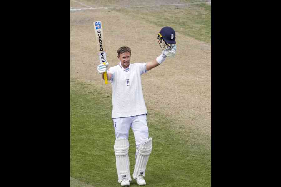 England's Joe Root celebrates his century on day three of the fourth test cricket match between India and England, at the Old Trafford Cricket Ground, in Manchester