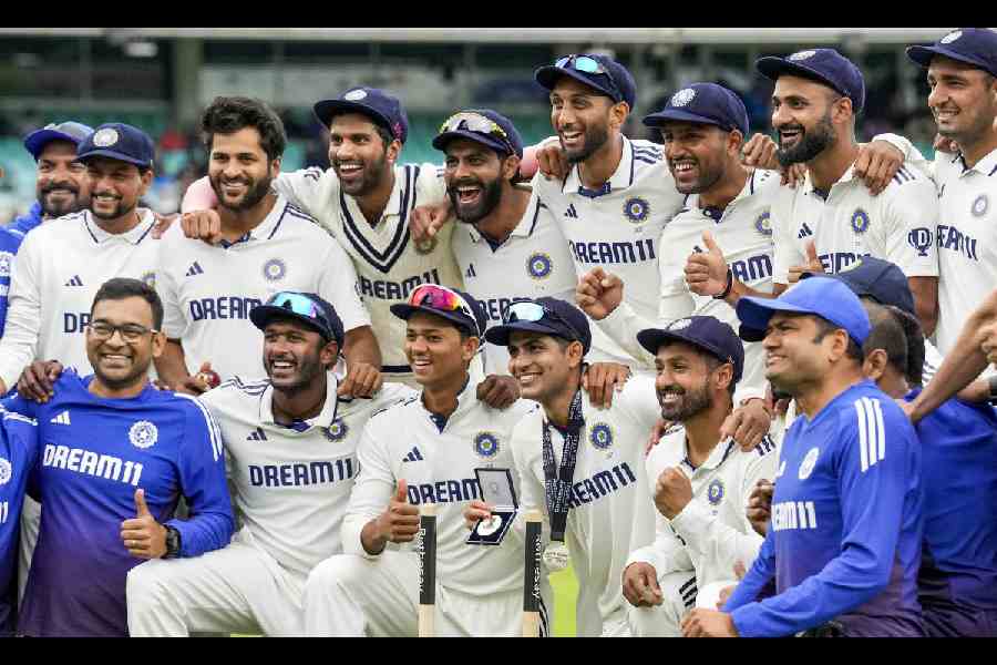 Indian team members pose for pictures following their victory in the fifth Test match against England, at The Oval cricket ground, in London, England, Monday, Aug. 4, 2025.