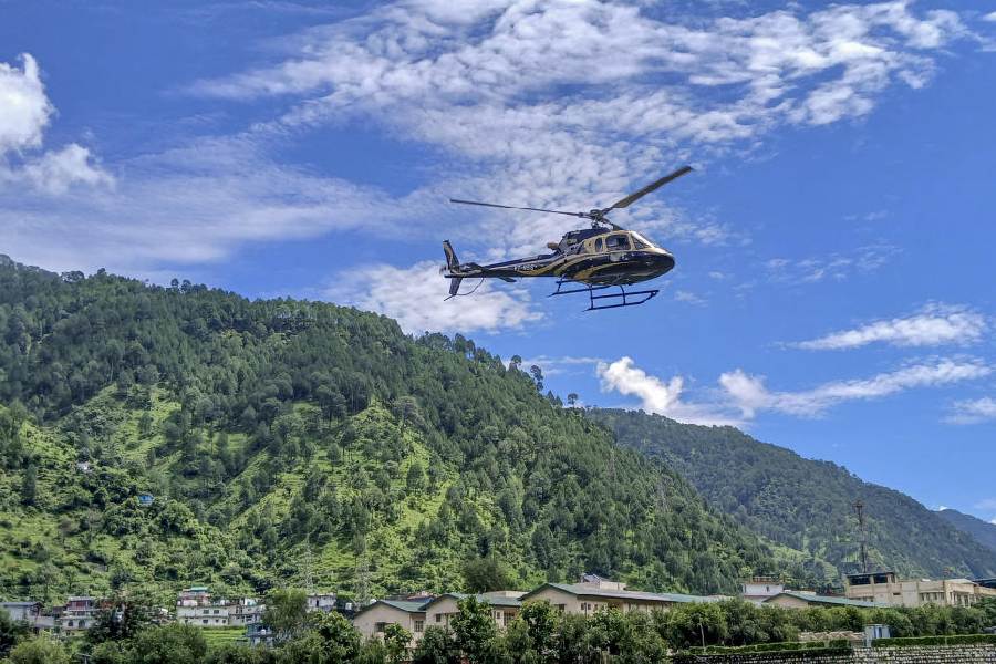 A helicopter carrying people evacuated from cloudburst-hit Dharali arrives at Matli, in Uttarkashi, Thursday, Aug. 7, 2025.