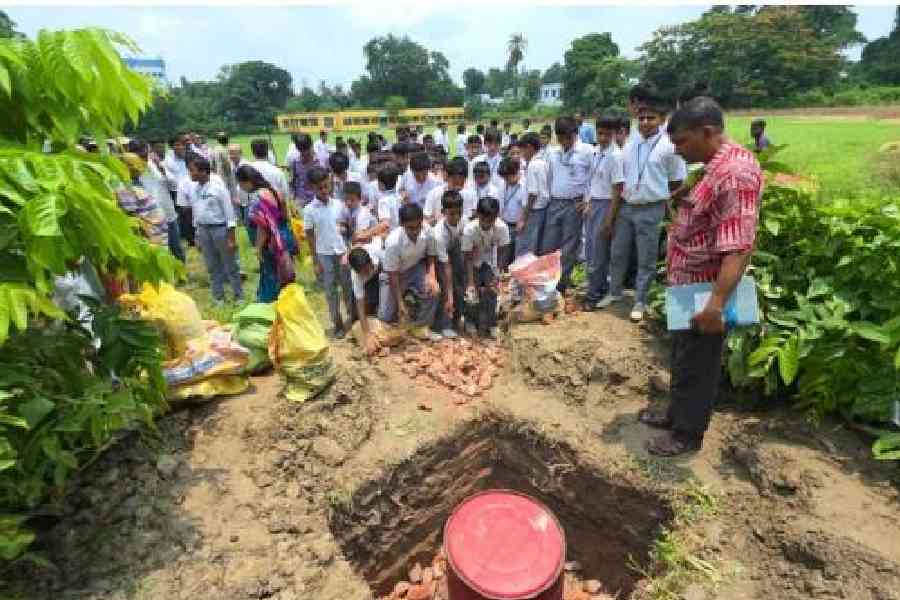 LIQUID LESSON: Students of Krishnagar Collegiate School help set up percolation pits on the school premises