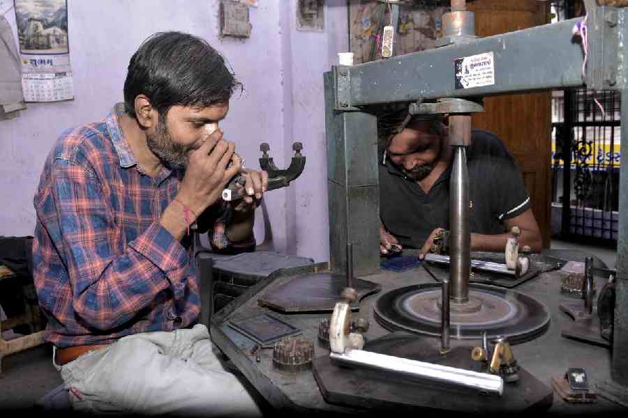 Surat: Craftsmen work on a diamond at a manufacturing unit, in Surat, Gujarat, Friday, Aug. 8, 2025.