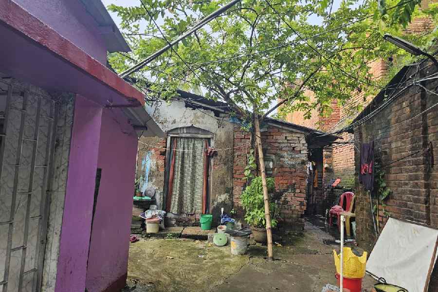 The path leading by a temple towards more illegal brick-andmortar huts beside the western side of Clive House