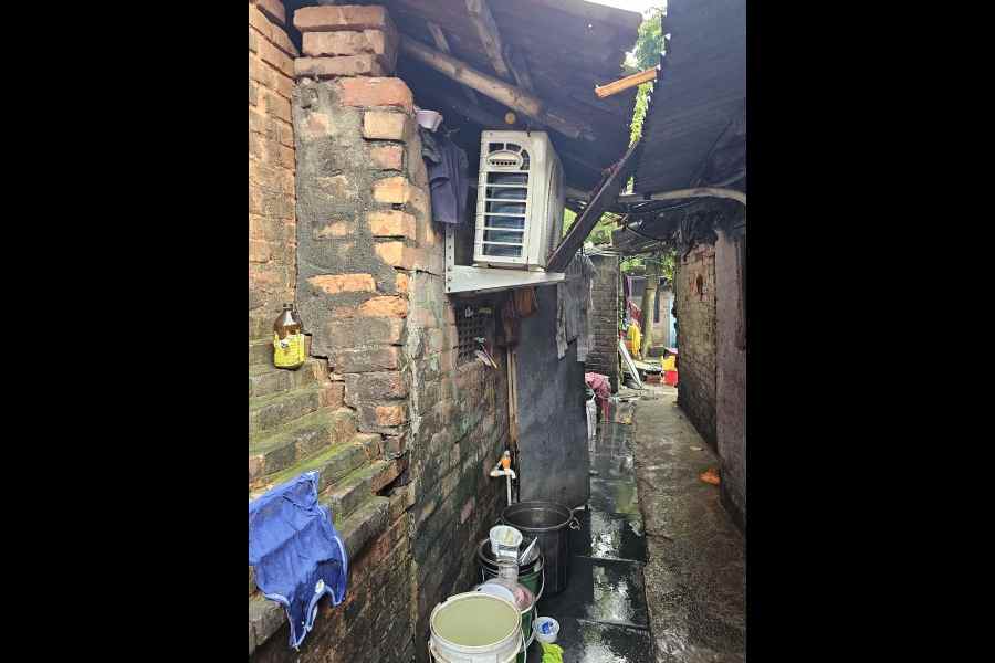 An air-conditioner’s outdoor unit and a water pipeline hammered to the Clive House wall by squatters