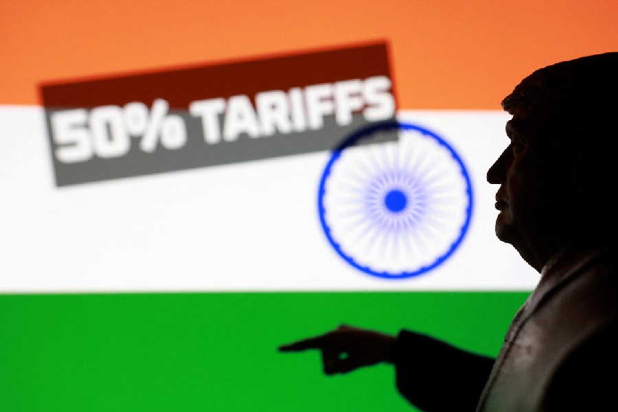 Indian flag, 3D-printed miniature model depicting U.S. President Donald Trump and phrase "50% tariffs", are seen in this illustration taken August 27, 2025.