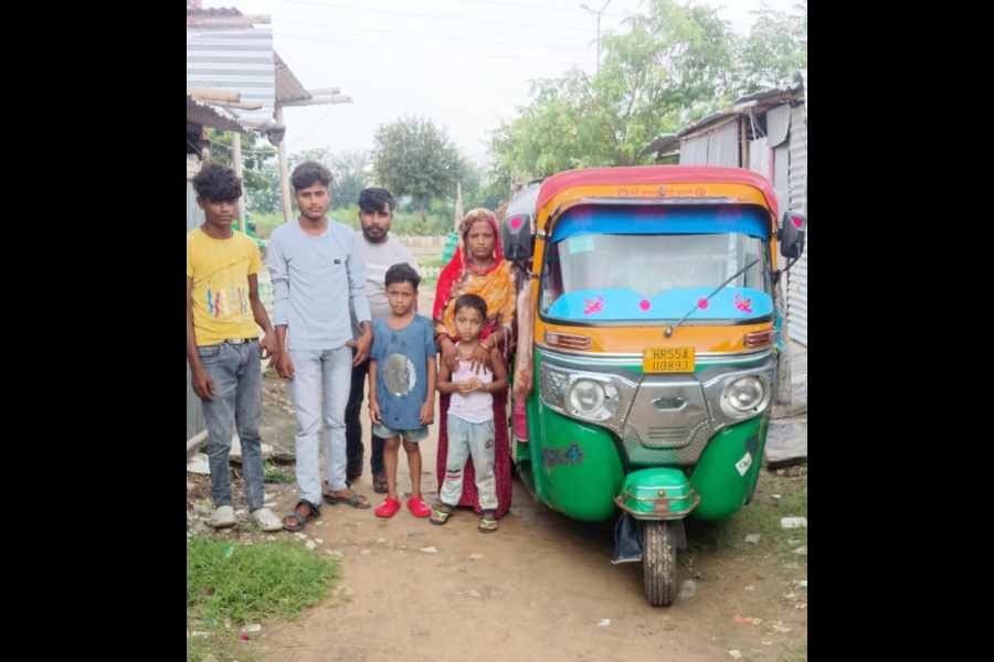 Jafar Ali with his family and auto rickshaw in Gurgaon on Saturday.