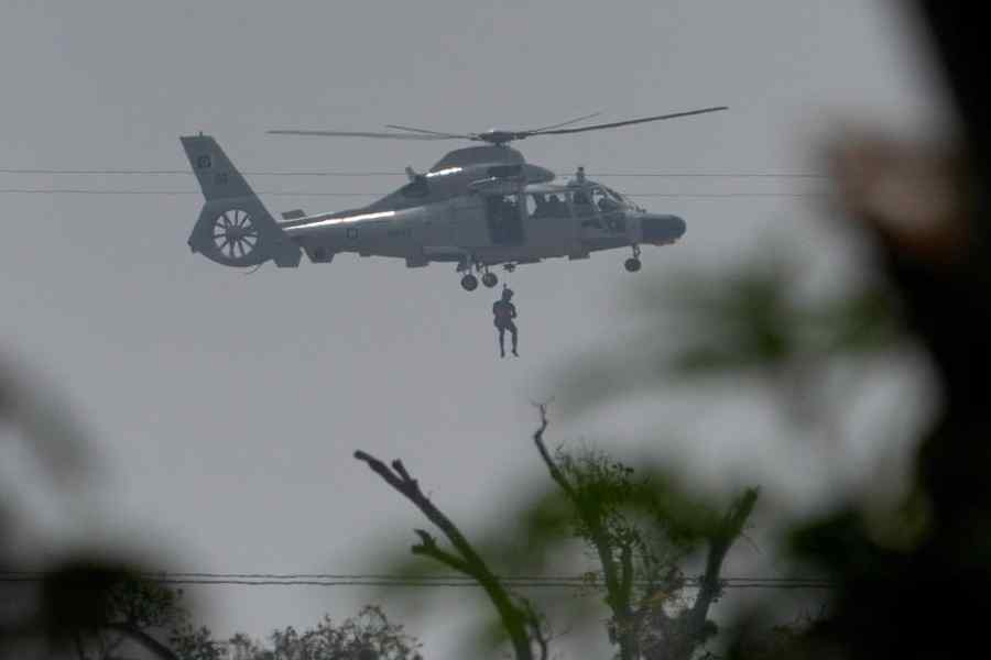 A Pakistan Navy helicopter airlifts a man who was stuck in a flooded area following Cyclone Ditwah in Kolonnawa, Sri Lanka, December 1, 2025.