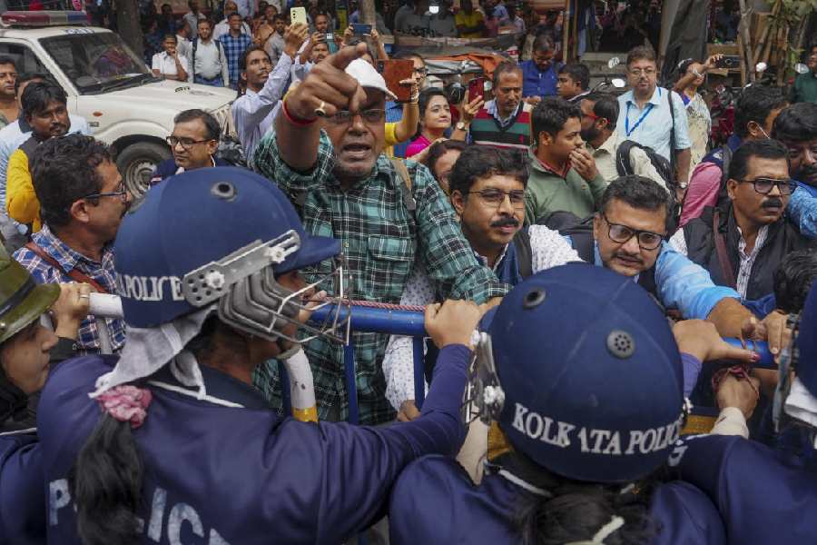 Booth-level officers under the banner of ‘BLO Adhikar Raksha Committee’ stage a protest over alleged excessive workload during the ongoing SIR, outside the chief electoral officer’s office in Calcutta on Monday.