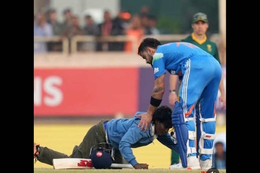 Soubhik Murmu touches Virat Kohli's feet at the stadium in Ranchi, Jharkhand, on Sunday