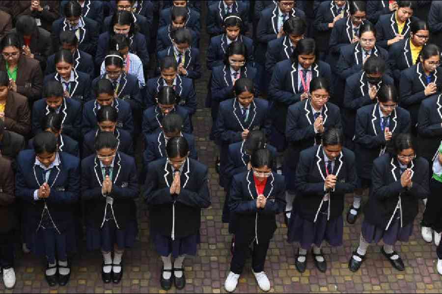Students of WWA Cossipore English School observe a minute’s silence in memory of Aranya Chakraborty            during the school assembly on Monday. Picture by Sanat Kr Sinha