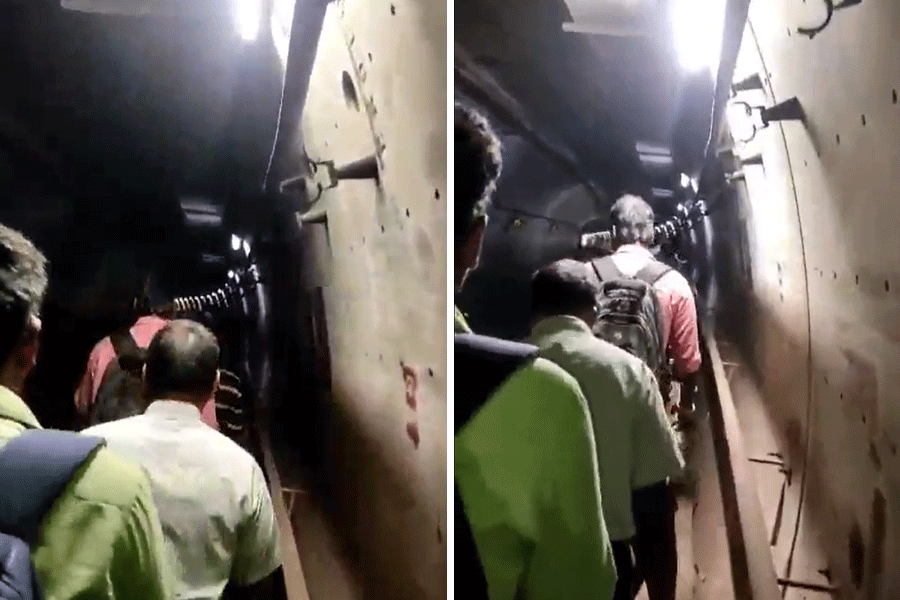 Commuters walk through the tunnel to safety.