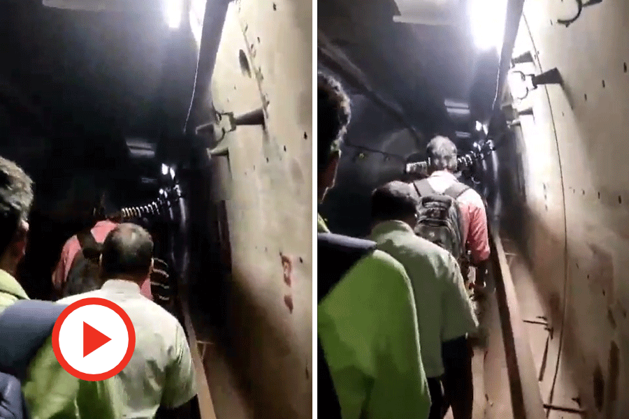 Commuters walk through the tunnel to safety.