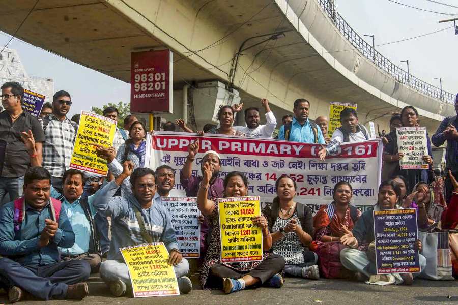 Candidates who passed the 2016 Upper Primary recruitment test participate in a protest march demanding immediate recruitment, in Kolkata, Monday, Nov. 24, 2025.