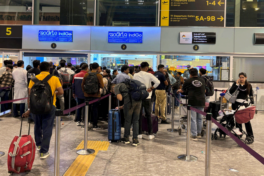 Travelers wait in queues at IndiGo ticketing kiosks to reschedule their flights at Kempegowda International Airport in Bengaluru, India, December 3, 2025.