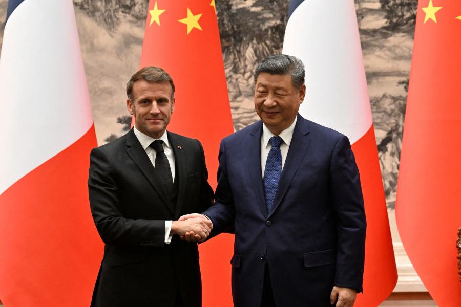 France’s President Emmanuel Macron (L) and China’s President Xi Jinping (R) shake hands after a joint press conference at the Great Hall of the People in Beijing on December 4, 2025.
