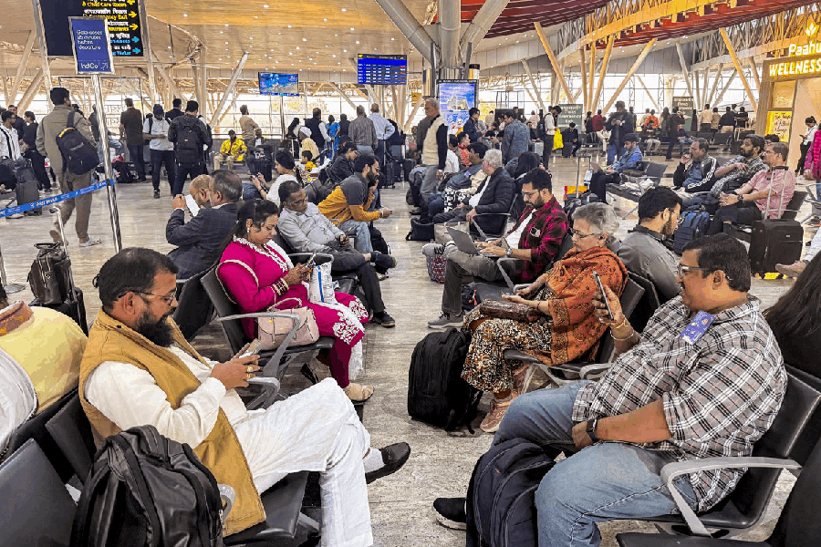 Passengers wait at Swami Vivekananda Airport, in Raipur, Chhattisgarh, Thursday, Dec. 4, 2025. IndiGo on Thursday cancelled more than 300 domestic and international flights at Delhi, Mumbai, Bangalore, and other airports, as operational disruptions continued for the third day, impacting the travel plans of hundreds of passengers.
