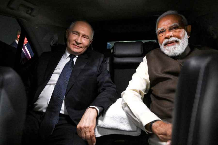 Vladimir Putin travels with Narendra Modi in the same car in New Delhi on Thursday. 