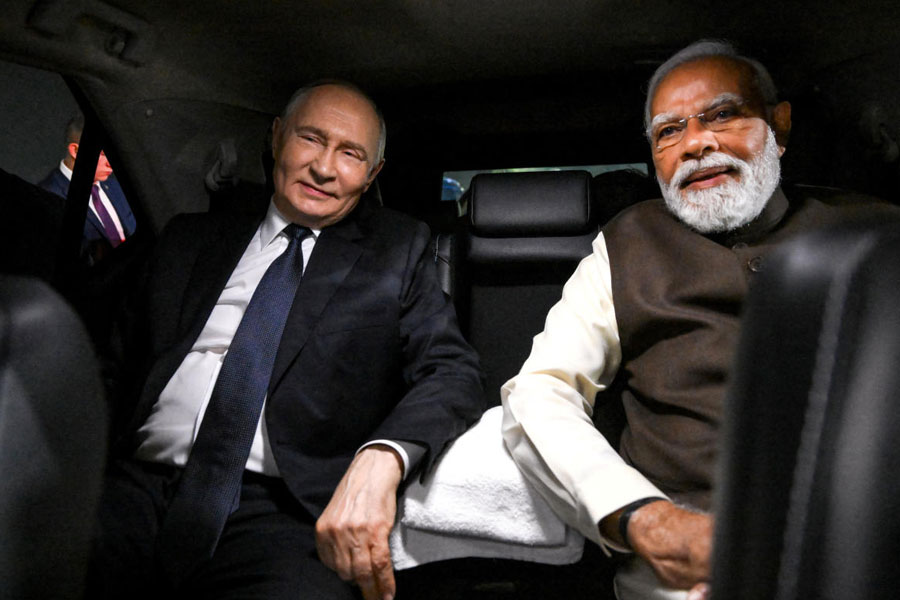 Russian President Vladimir Putin and Indian Prime Minister Narendra Modi sit in a car during a welcoming ceremony at the Palam Air Base in New Delhi, India December 4, 2025.
