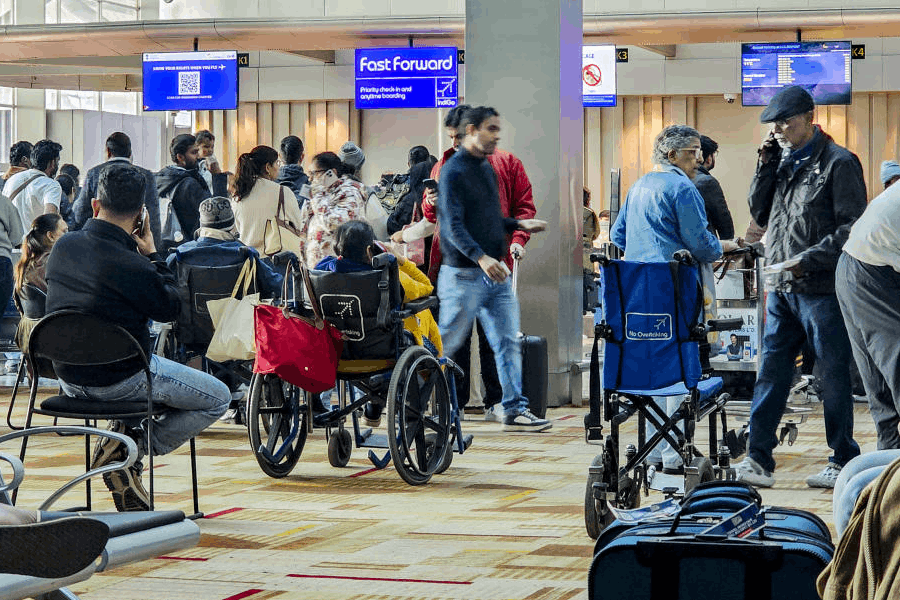 Passengers wait counters of the IndiGo airline, at Terminal 1 (T1) of the Indira Gandhi International Airport, in New Delhi, Saturday, Dec. 6, 2025. Domestic carrier IndiGo has cancelled over 200 flights from Delhi and Mumbai on Saturday, a day after managing to temporarily secure major relaxations in the second phase of the court-mandated new flight duty and rest period norms for cockpit crew, sources said.