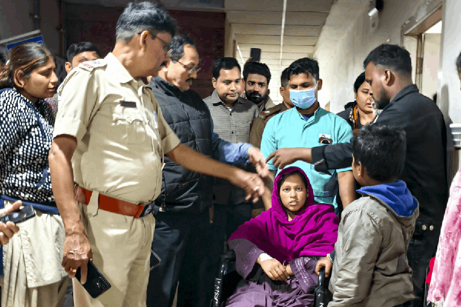 26-year-old Birbhum resident Sunali Khatun, on a wheelchair, is being sent home by the administration after spending a night at Malda Medical College and Hospital, in Malda district, West Bengal, Saturday, Dec. 6, 2025.