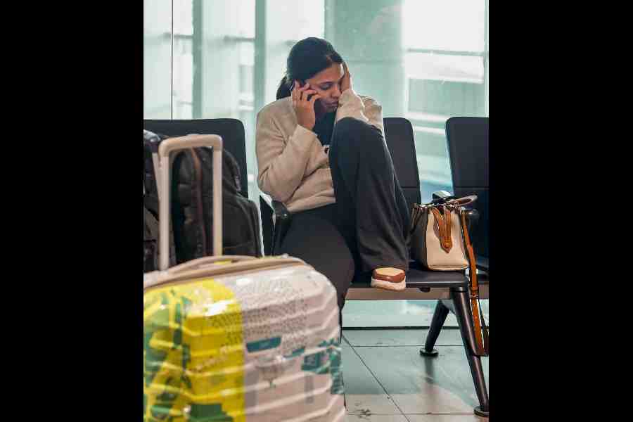 A stranded passenger waits at the Indira Gandhi International Airport in New Delhi on Saturday.