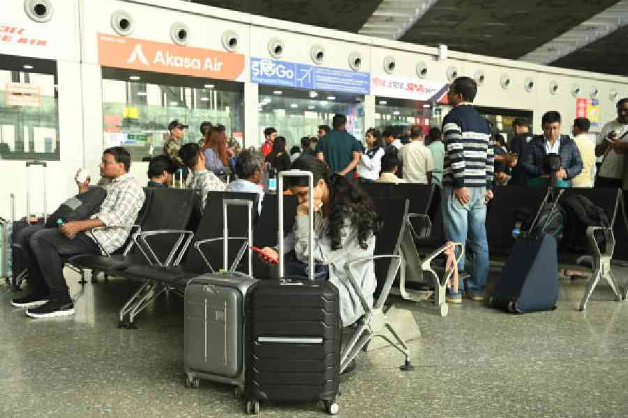 Passengers wait at the Calcutta airport on Sunday afternoon. Picture by Bishwarup Dutta