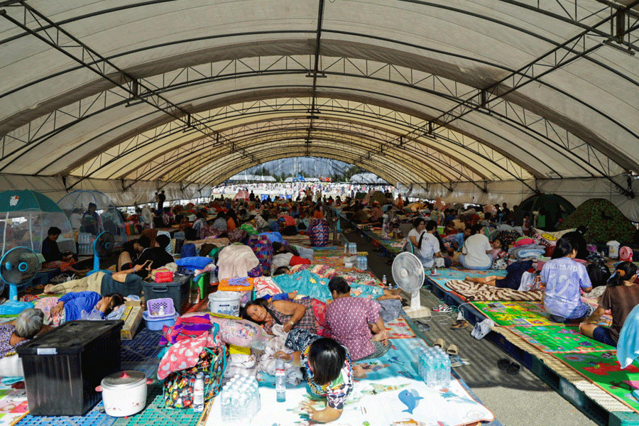 People rest at a shelter, following fresh military clashes between Thailand and Cambodia along parts of their disputed border, in Buriram province, Thailand, December 8, 2025.
