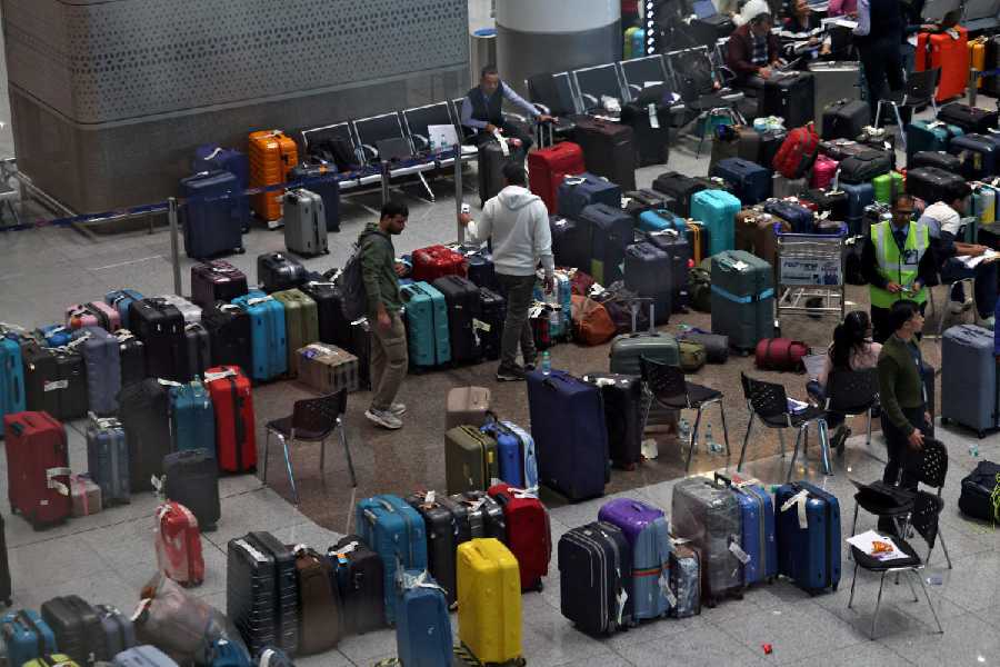 IndiGo staff tag stranded luggage of passengers at Delhi airport on Monday.