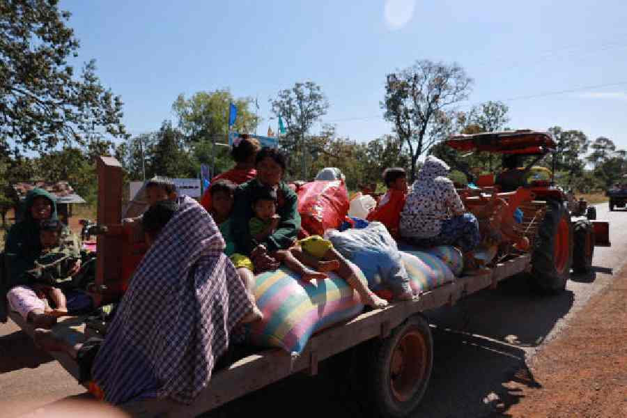 People flee a disputed border area in Oddar Meanchey Province, Cambodia, on Monday.