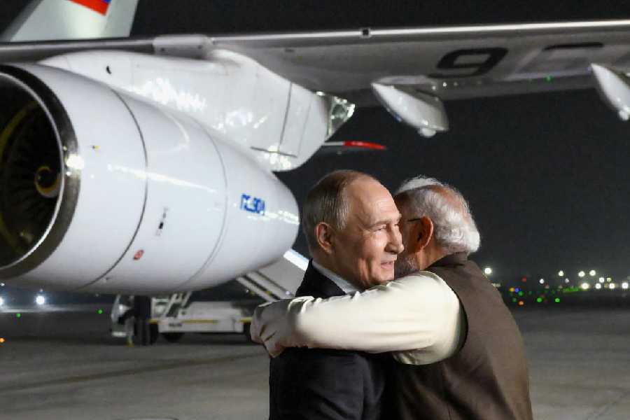 Russian President Vladimir Putin, left, and Indian Prime Minister Narendra Modi embrace each other at the Palam Air Base in New Delhi, India, on Thursday, Dec. 4, 2025.
