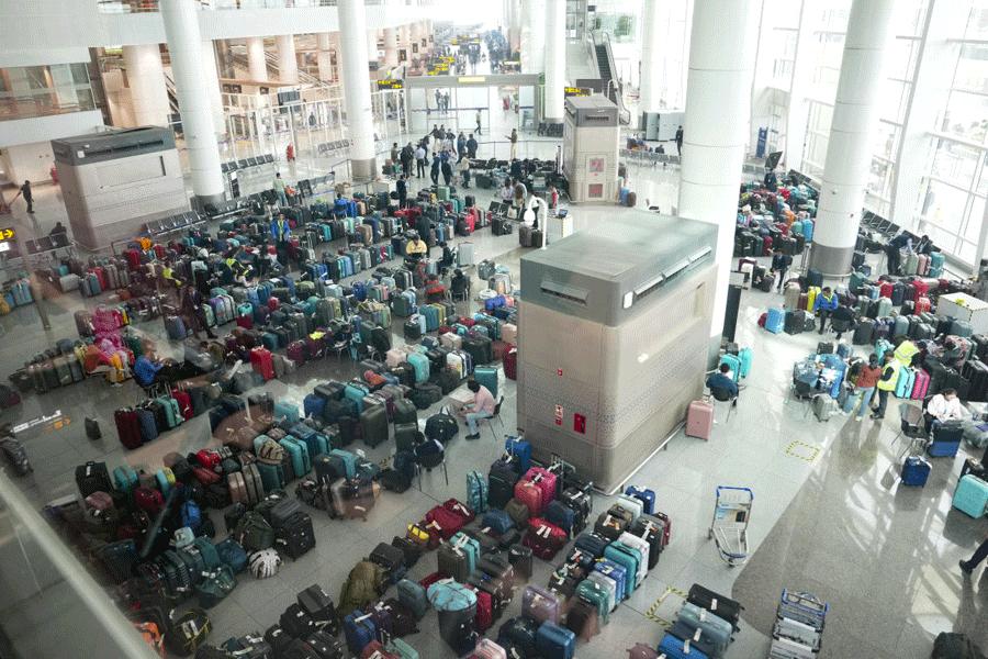 Luggage of passengers piled up at the Indira Gandhi International Airport amid IndiGo flight disruptions, in New Delhi, Monday, Dec. 8, 2025.