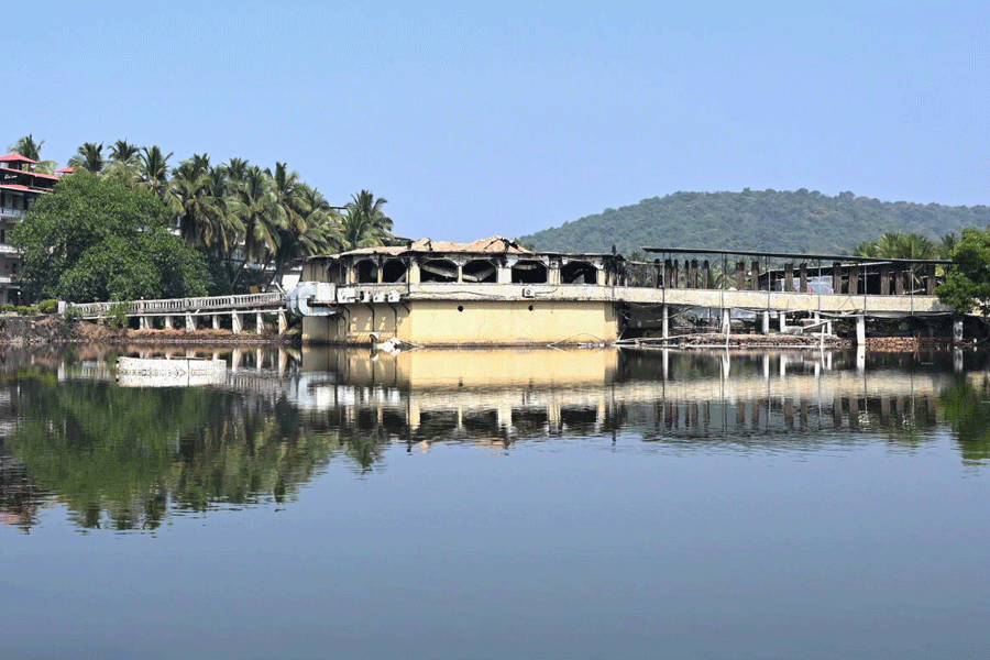 The nightclub, which caught fire on early Sunday, is seen across an expanse of water in Arpora, in Goa, India, Sunday, Dec. 7, 2025.
