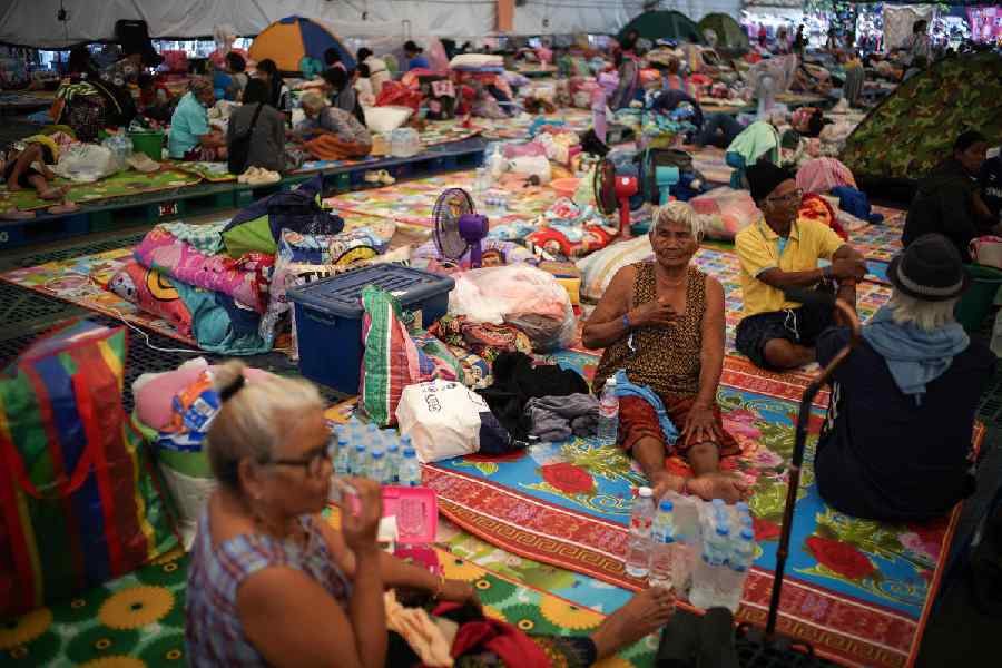 Displaced people gather inside a temporary shelter amid deadly clashes between Thailand and Cambodia along a disputed border area, in Buriram province, Thailand, December 9, 2025.