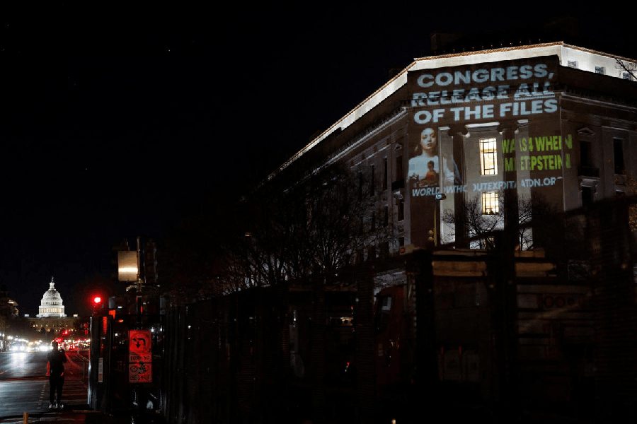 Members of the group World Without Exploitation project a message calling for U.S. Congress to fully release the Epstein Files, at the U.S. Department of Justice building in Washington, D.C, U.S., November 17, 2025.
