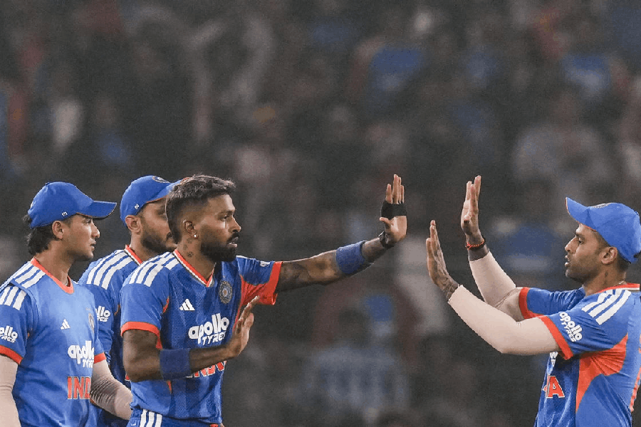 Hardik Pandya celebrates with Suryakumar Yadav after taking the wicket of South Africa's David Miller during the first T20I cricket match between India and South Africa at Barabati Stadium, in Cuttack, Tuesday, Dec. 9, 2025.