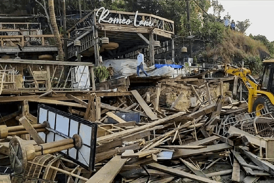 An excavator demolishes wooden structures at Romeo Lane on Anjuna beach after a fire at the adjacent Birch by Romeo Lane nightclub killed 25 people, as the state administration begins pulling down the tourism property, in Goa, Tuesday, Dec. 9, 2025.