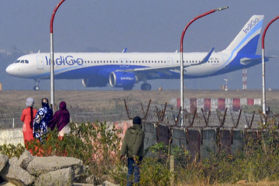 People look on as an Indigo airplane prepares for takeoff even as several flights of the airline were cancelled or delayed, at Birsa Munda Airport in Ranchi, Tuesday, Dec. 9, 2025.