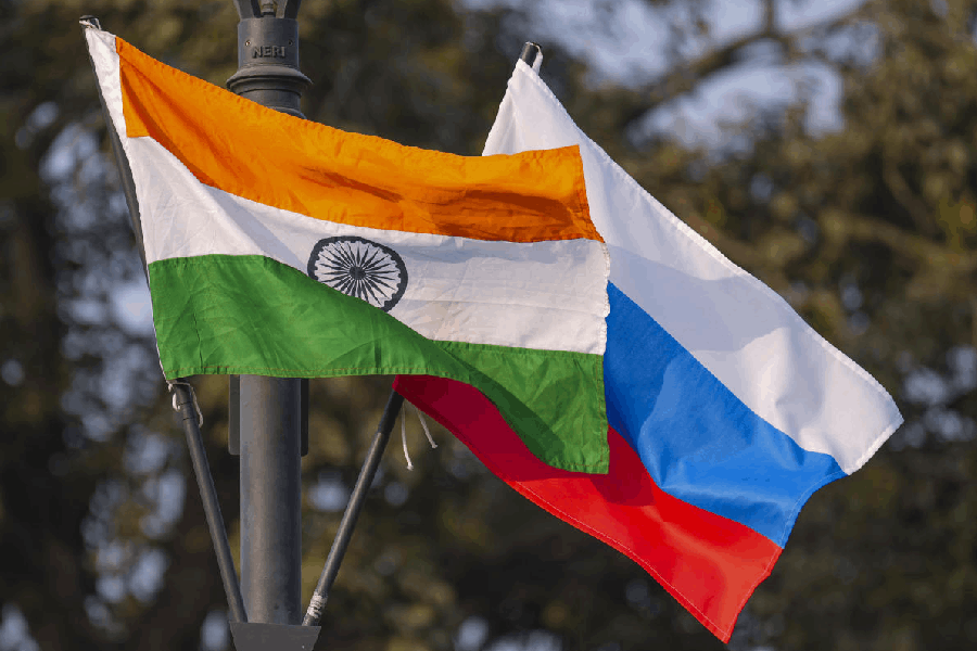 The Indian national flag and the Russian flag flutter on lamp posts along Kartavya Path in New Delhi.