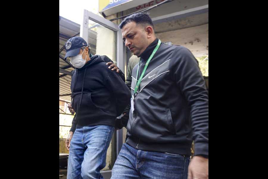 Ajay Gupta (left), another owner of the Goa nightclub, being brought to the crime branch office in New Delhi on Wednesday.