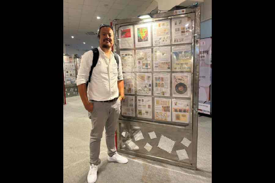 Vivek Yonzone with his collection of stamps. 