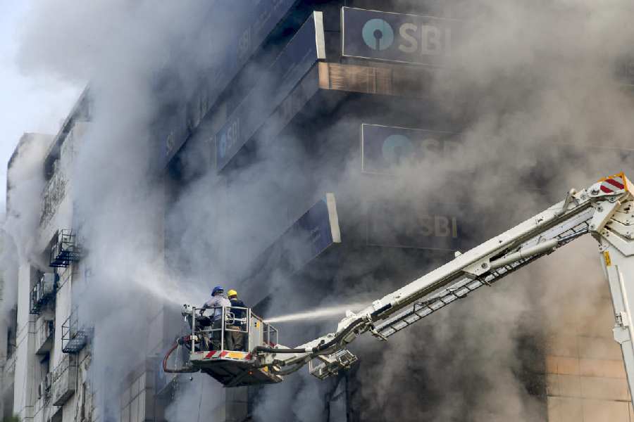 Firefighters try to douse a fire that broke out at Swagota Square, Sohum Emporia, in Guwahati