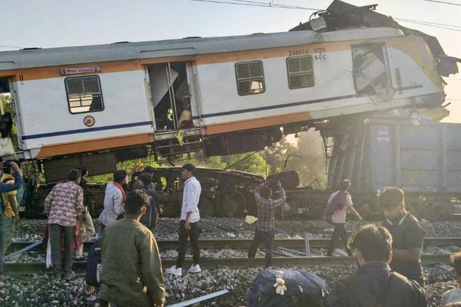 People gather after a passenger train collided with a goods train near Bilaspur railway station, Chhattisgarh, Tuesday, Nov. 4, 2025. Two people have been injured in the incident.