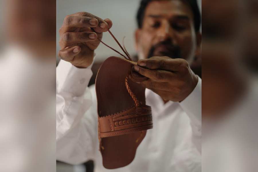 A craftsman works on limited-edition Prada leather sandals inspired by India's traditional Kolhapuri footwear, inside a facility in Kolhapur, Maharashtra, India, December 8, 2025