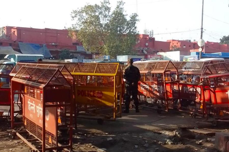 A security official stands guard a heavily-barricaded roadside near the Red Fort complex, in New Delhi, Thursday, Dec. 11, 2025.
