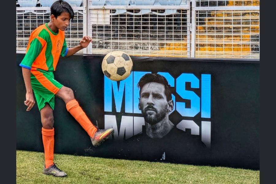 One of the youngsters practises juggling right in front of a Messi advert