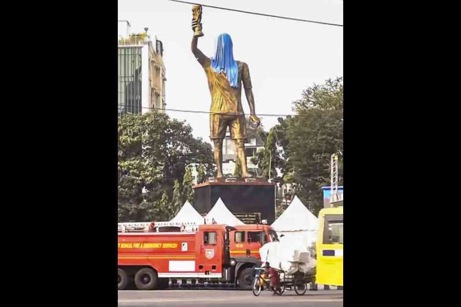 A partially covered 70-feet statue of Argentine footballer and 2022 FIFA World Cup winning captain Lionel Messi, seen amid preparations for his scheduled visit to Kolkata