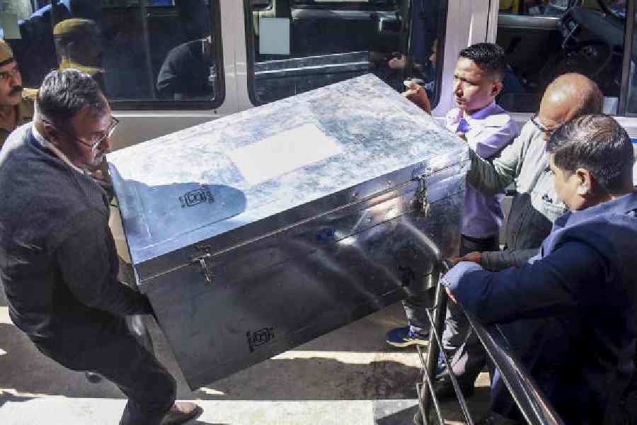 SIT officials carry a trunk containing statement records into the court in Guwahati on Friday.