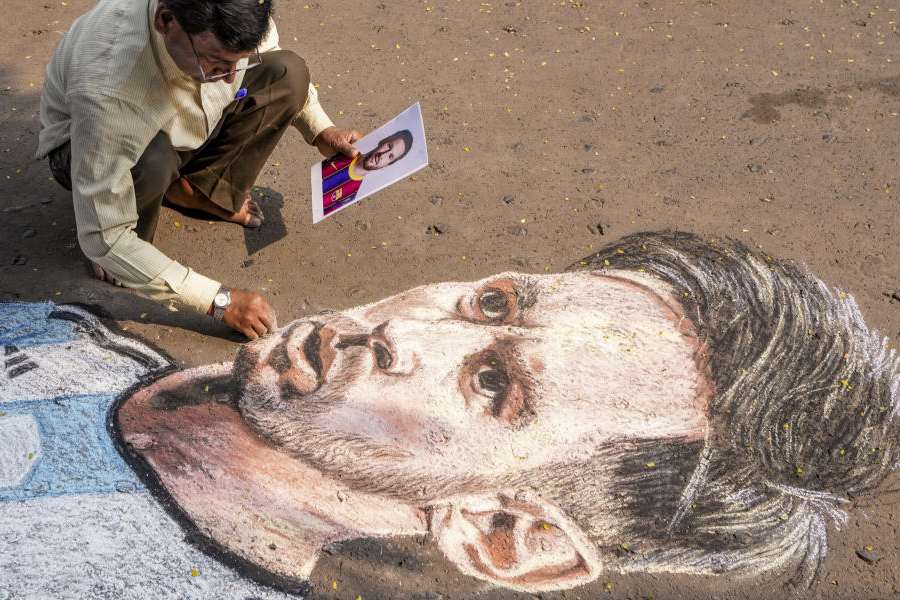 Artist Swapan Kumar Das draws a portrait of Argentine footballer and 2022 FIFA World Cup winning captain Lionel Messi ahead of his visit, in Kolkata, West Bengal, Friday, Dec. 12, 2025.