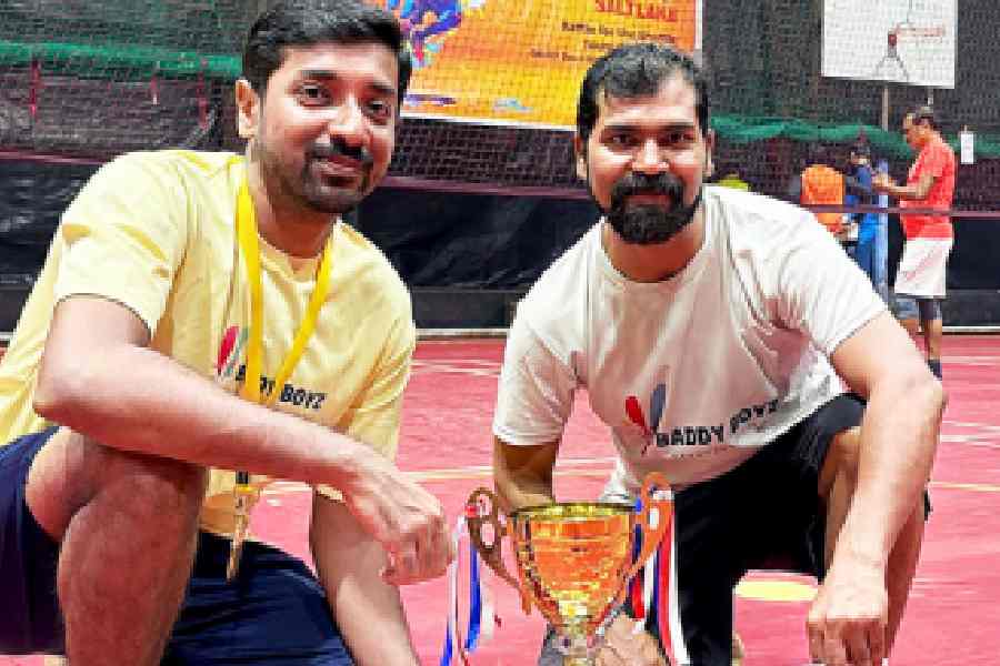The men’s 70+ champions, both residents of Siddha Town, with their trophy